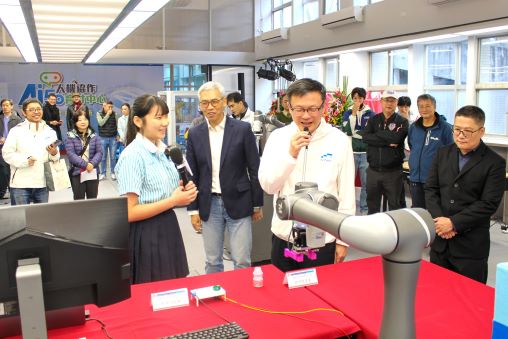 技教工場升級 三重商工AI 5.0人機協作育才中心啟用 9 《圖說》三重商工機械科三年級黃盈蓁同學陪同張明文局長進行智慧型機器手臂運作。〈教育局提供〉