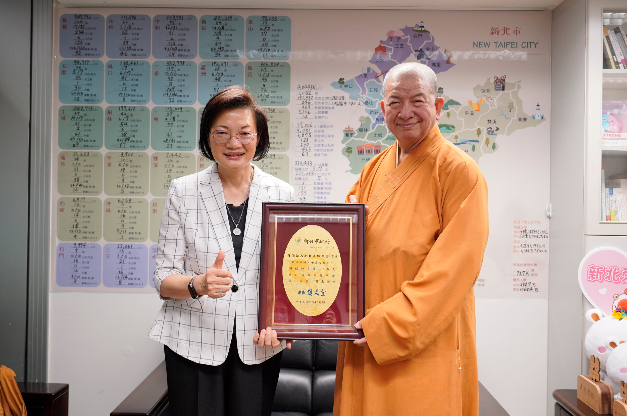 《圖說》社會局長李美珍代表代表侯友宜市長回贈感謝牌給釋明光法師。〈社會局提供〉