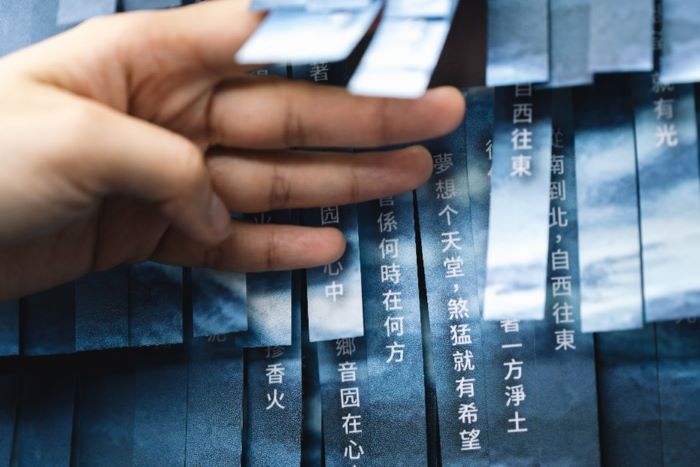 新北客家雙喜臨門 教學績優連霸、英國設計雙金耀國際 8 《圖說》新北市立圖書館總館的客家閱讀專區,以剪紙層次堆疊出起伏波濤的「剪紙堆疊詩牆」,使並呈現客籍詩人王興寶的作品《夢想个天堂》。〈客家局提供〉