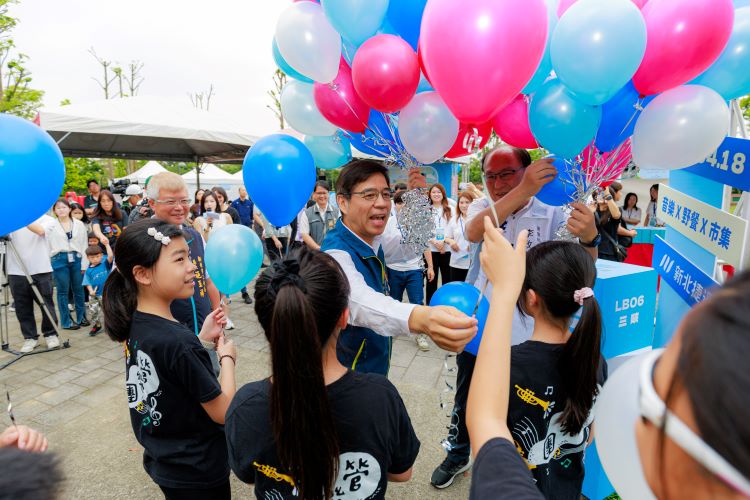 《圖說》柯慶忠副秘書長發送氣球給小朋友。〈捷運局提供〉